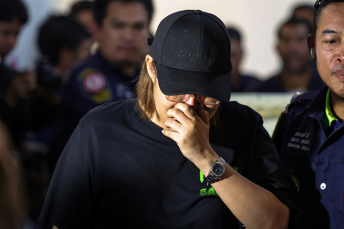 A family member reacts as she receives the body of a victim at the Police Hospital morgue, following a deadly fire at a pub in Bangkok, Thailand, July 14, 2026. REUTERS/Athit Perawongmetha