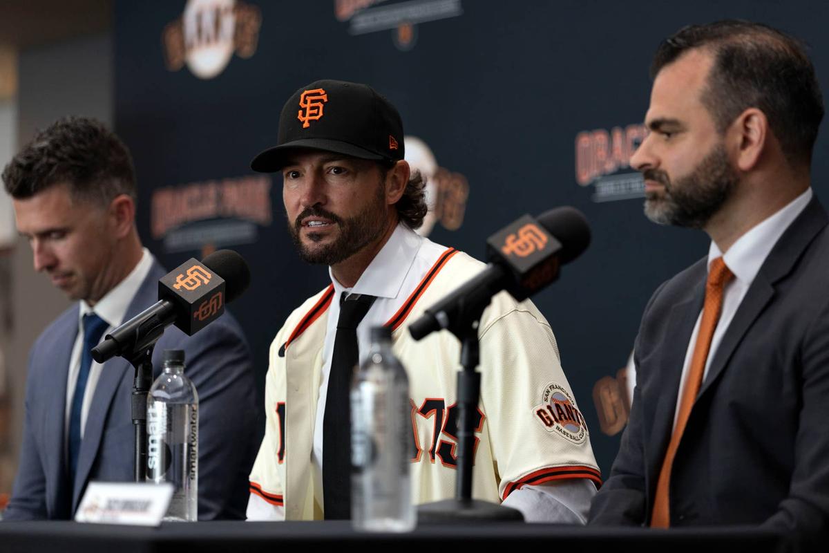  Tony Vitello (center) answers questions from the media as he is introduced as the new manager of the San Francisco Giants at Oracle Park. He is flanked by president of baseball operations Buster Posey (left) and general manager Zack Minasian. 