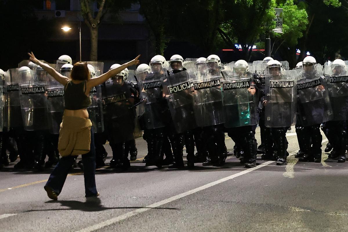 A demonstrator gestures by riot police, during a student-led protest demanding snap parliamentary elections, as Serbia's anti-corruption movement enters a new phase, following the Novi Sad railway station canopy collapse that killed 16 people in 2024, in Belgrade, Serbia, May 23, 2026. REUTERS/Zorana Jevtic