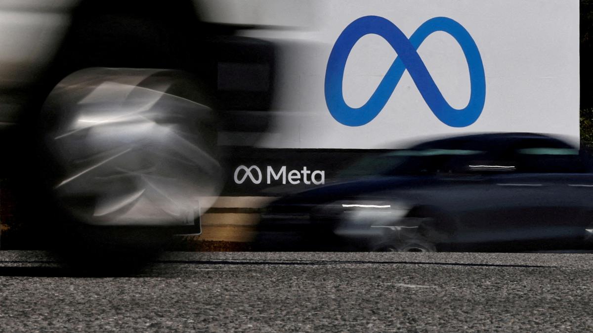 FILE PHOTO: FILE PHOTO: Cars drive past a sign of Meta, the new name for the company formerly known as Facebook, at its headquarters in Menlo Park, California, U.S. October 28, 2021. REUTERS/Carlos Barria/File Photo/File Photo