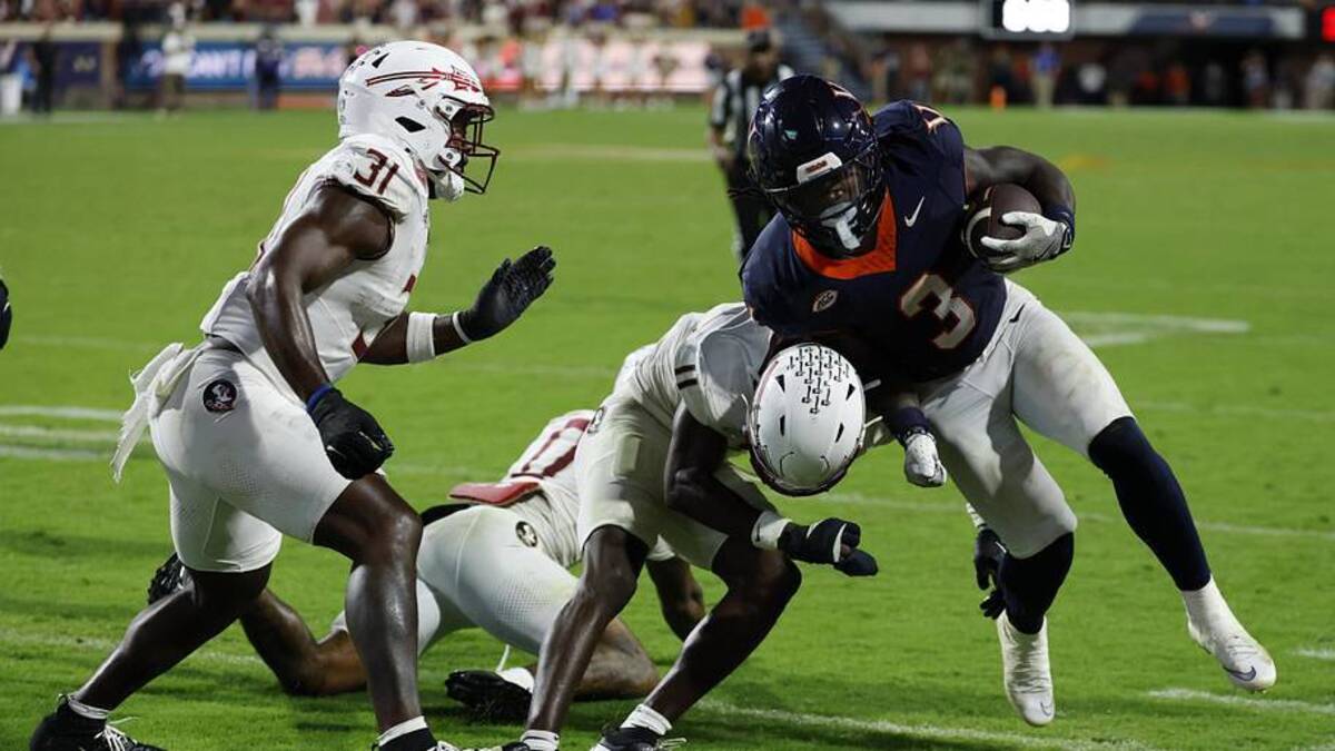  Sep 26, 2025; Charlottesville, Virginia, USA; Virginia Cavaliers running back J'Mari Taylor (3) carries the ball as Florida State Seminoles defensive back Ja'Bril Rawls (11) tackles in the second overtime at Scott Stadium. Mandatory Credit: Geoff Burke-Imagn Images | Geoff Burke-Imagn Images 