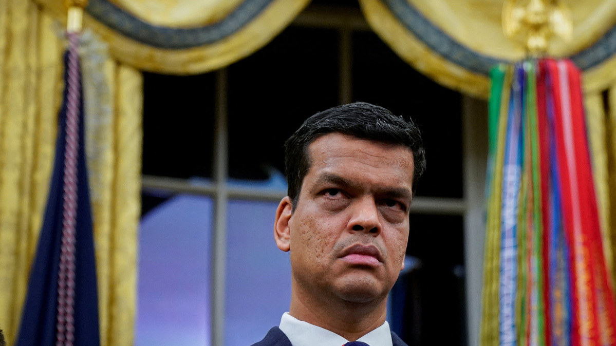 Sriram Krishnan, Senior White House Policy Advisor on Artificial Intelligence, listens prior to U.S. President Donald Trump (not pictured) signing an executive order on AI in the Oval Office at the White House in Washington, D.C., U.S. December 11, 2025. REUTERS/Al Drago
