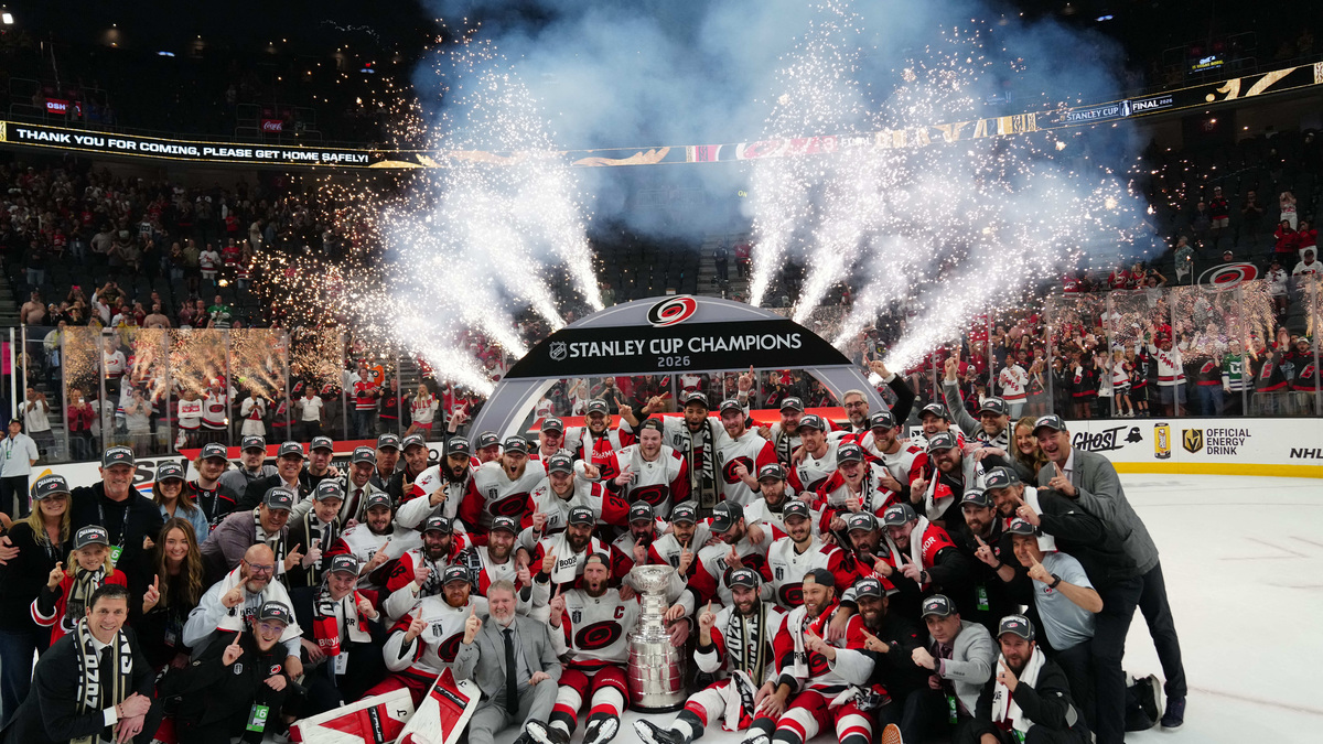 Jun 14, 2026; Las Vegas, Nevada, USA; The Carolina Hurricanes pose with the the Stanley Cup after defeating Vegas Golden Knights in game six of the 2026 Stanley Cup Final at T-Mobile Arena. Mandatory Credit: Stephen R. Sylvanie-Imagn Images