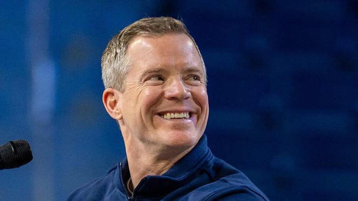  Michigan head coach Dusty May smiles at the podium during a celebration honoring the Wolverines' NCAA men's basketball national championship at Crisler Center in Ann Arbor on Saturday, April 11, 2026. | David Rodriguez Muñoz / USA TODAY NETWORK via Imagn Images 