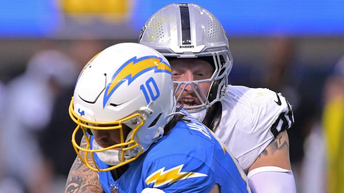  Oct 1, 2023; Inglewood, California, USA; Los Angeles Chargers quarterback Justin Herbert (10) is sacked by Las Vegas Raiders defensive end Maxx Crosby (98) in the fourth quarter at SoFi Stadium. Mandatory Credit: Jayne Kamin-Oncea-Imagn Images | Jayne Kamin-Oncea-Imagn Images 