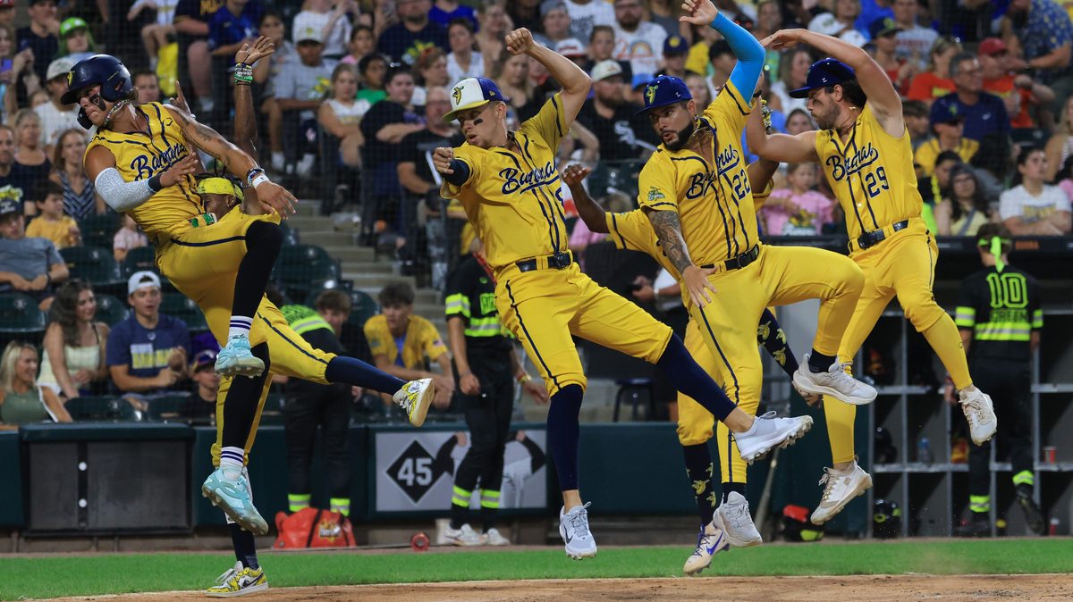 Savannah Bananas players perform a dance at the plate in the fourth inning against the Firefighters on Aug. 15, 2025, at Rate Field. (John J. Kim/Chicago Tribune)