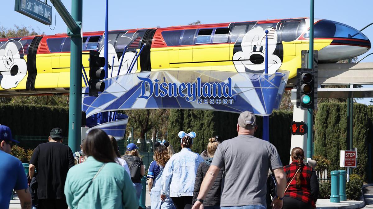 Disneyland and California Adventure guests enter the park as the monorail passes by the entrance to Disneyland in Anaheim, California, on March 11, 2024. (Allen J. Schaben/Los Angeles Times/TNS)