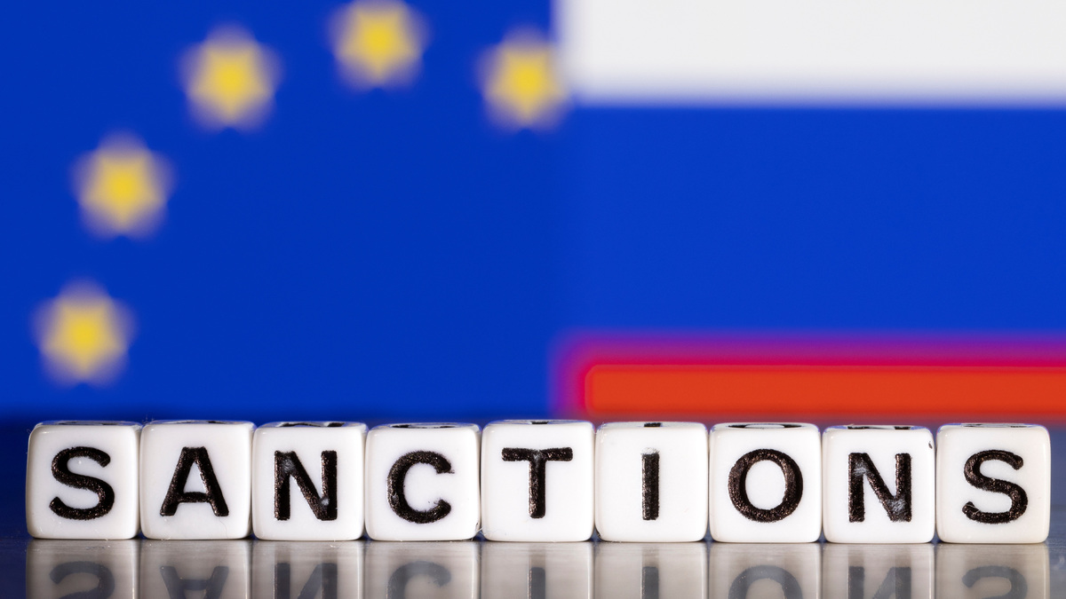 Plastic letters arranged to read "Sanctions" are placed in front the flag colors of EU and Russia in this illustration taken February 28, 2022. REUTERS/Dado Ruvic/Illustration