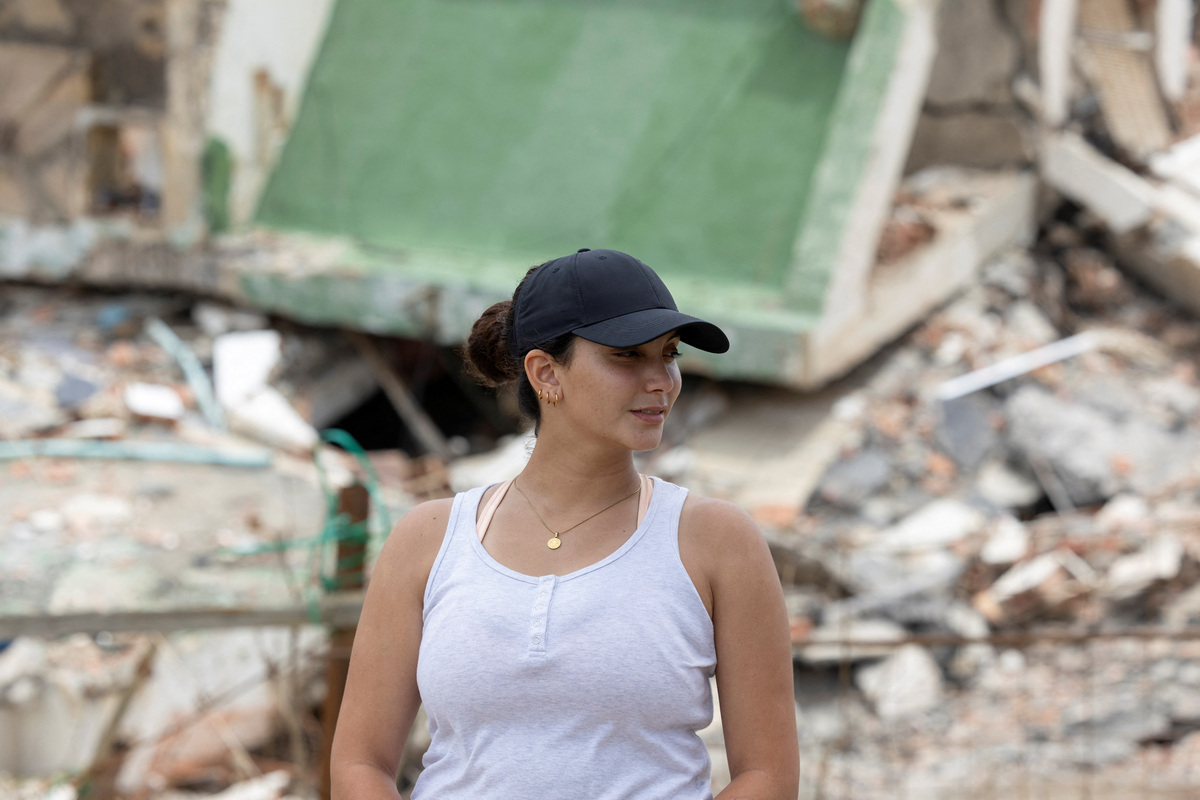 Maria Alejandra Sanz, 17, stands in front of the remains of her apartment building after twin earthquakes struck La Guaira, Venezuela, July 5, 2026. REUTERS/Ricardo Arduengo