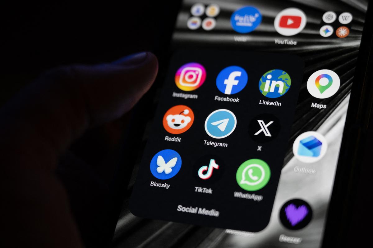  Stock image of a smartphone screen displaying the logos of popular social media platforms. 