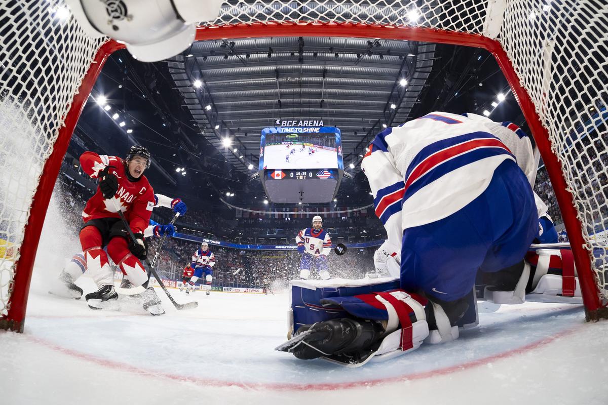 Ice Hockey - IIHF World Championships - Quarter Final - Canada v United States - BCF Arena, Fribourg, Switzerland - May 28, 2026 Canada's Macklin Celebrini in action with Devin Cooley of the U.S. Pool via REUTERS/Anthony Anex