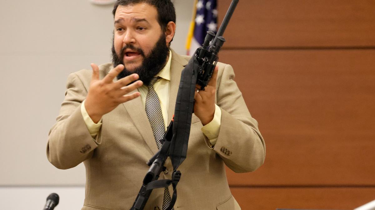 Broward County Sheriff’s Office crime lab manager George Bello holds the weapon used by Marjory Stoneman Douglas High School shooter Nikolas Cruz during the penalty phase of Cruz’s trial at the Broward County Courthouse on Aug. 2.