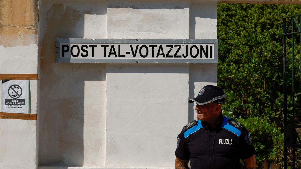 A police officer stands in front of a polling station during Malta's general election, in Zejtun, Malta, May 30, 2026.  REUTERS/Darrin Zammit Lupi