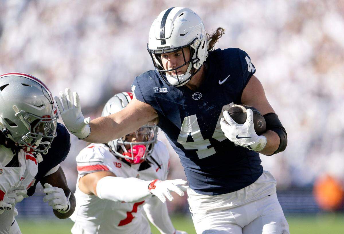 Penn State tight end Tyler Warren pushes past Ohio State defenders with the ball during the game on Nov. 2, 2024 at Beaver Stadium.