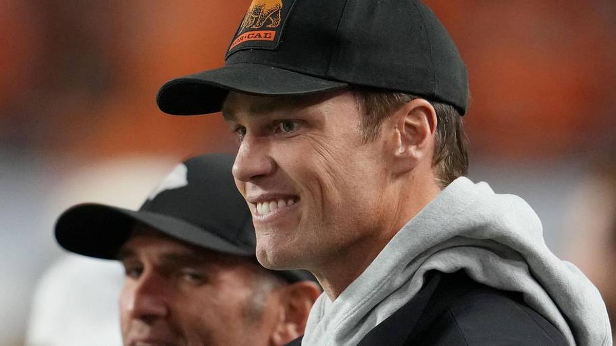 Jan 19, 2026; Miami Gardens, FL, USA; Tom Brady looks on from the sideline before the CFP National Championship college football game between the Indiana Hoosiers and the Miami Hurricanes at Hard Rock Stadium. Mandatory Credit: Kirby Lee-Imagn Images | Kirby Lee-Imagn Images 