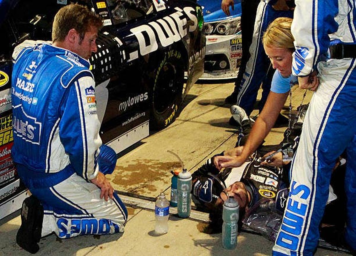  Jimmie Johnson lies heat-exhausted after the NASCAR Sprint Cup Series. (Photo by Brian Lawdermilk/Getty Images) (Photo by Brian Lawdermilk/Getty Images