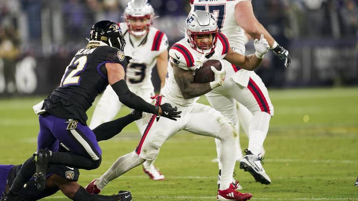  Dec 21, 2025; Baltimore, Maryland, USA; New England Patriots running back Treveyon Henderson (32) runs the ball against Baltimore Ravens safety Alohi Gilman (12) during the first half of the game at M&T Bank Stadium. Mandatory Credit: Mitch Stringer-Imagn Images | Mitch Stringer-Imagn Images 