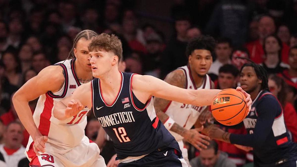  Mar 14, 2026; New York, NY, USA; Connecticut Huskies center Eric Reibe (12) works around St. John's Red Storm forward Rubén Prey (17) during the first half of the men's Big East Conference Tournament Championship at Madison Square Garden. Mandatory Credit: Robert Deutsch-Imagn Images | Robert Deutsch-Imagn Images 