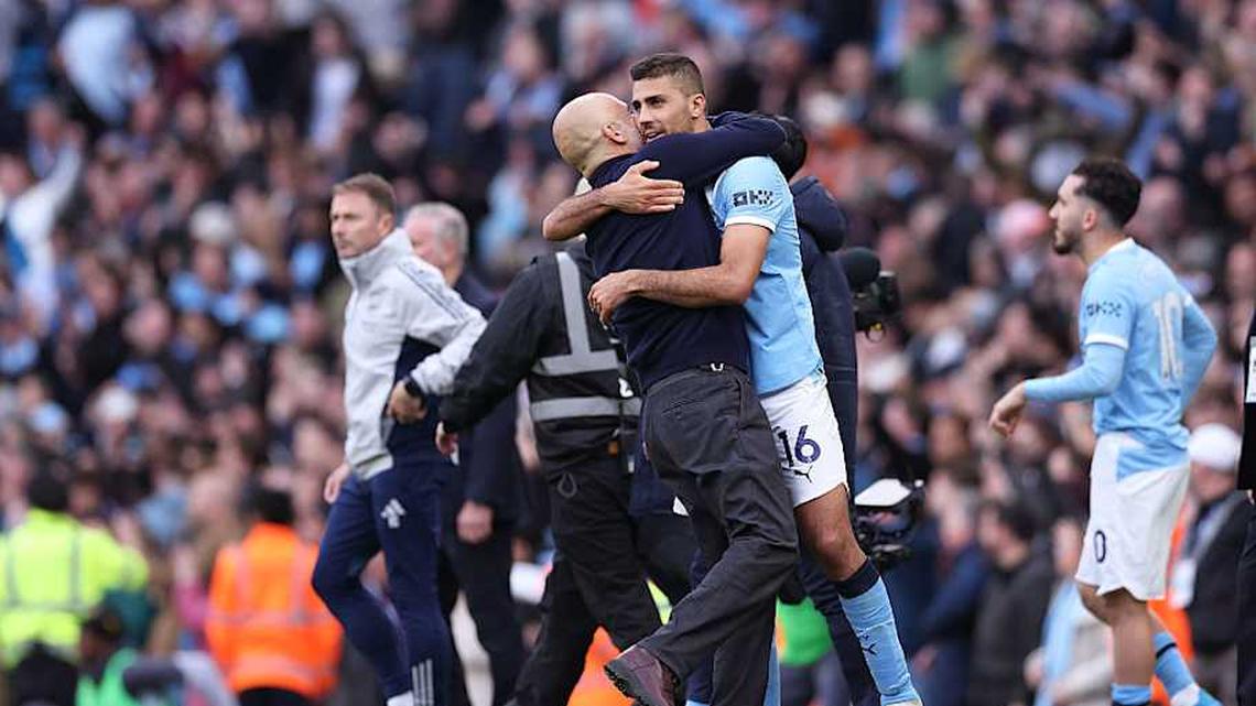  Guardiola embraced his midfield star after a mammoth victory. | Alex Livesey/Danehouse/Getty Images 