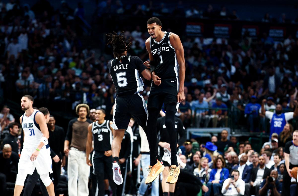 Oct 22, 2025; Dallas, Texas, USA;   San Antonio Spurs forward Victor Wembanyama (1) celebrates with San Antonio Spurs guard Stephon Castle (5) during the first half  against the Dallas Mavericks at American Airlines Center. Mandatory Credit: Kevin Jairaj-Imagn Images