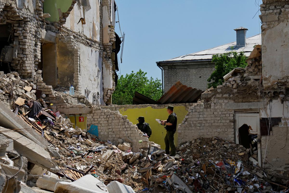 Investigators work at the destroyed dormitory building of the Starobilsk College of Luhansk Pedagogical University following a recent attack, which Russian authorities called a Ukrainian drone strike, in the course of the Russia-Ukraine conflict in the town of Starobilsk (Starobelsk) in the Luhansk region, a Russian-controlled area of Ukraine, May 24, 2026. Reuters reported from Starobilsk on a media facility trip organised by the Ministry of Foreign Affairs of the Russian Federation on May 24, 2026. REUTERS/Alexander Ermochenko