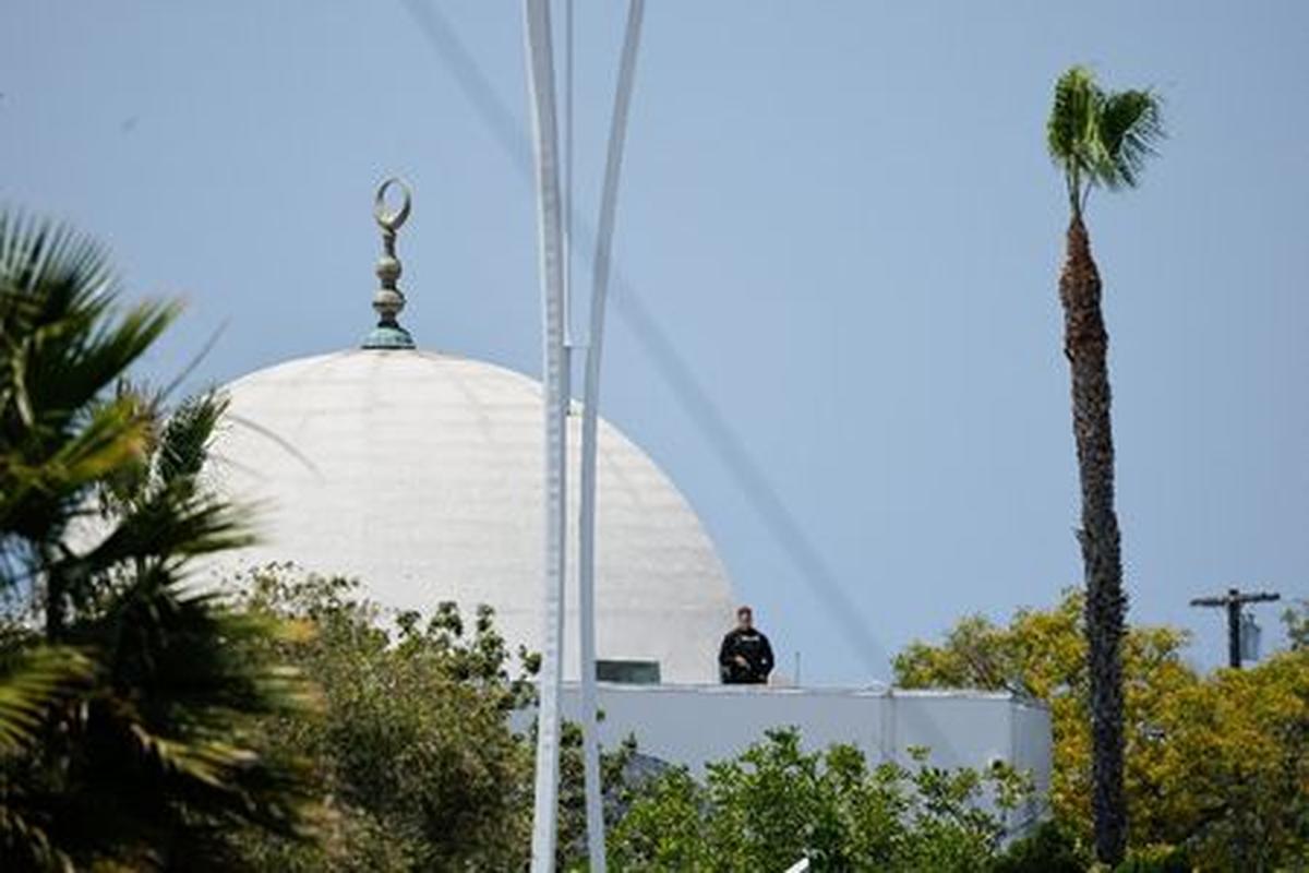 A police officer stands guard as emergency workers respond at the scene of a reported active shooter situation at the Islamic Center in San Diego, California, U.S., May 18, 2026.  REUTERS/Mike Blake