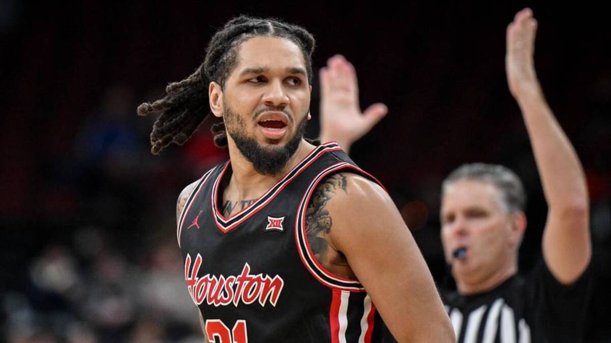 Dec 20, 2025; Newark, New Jersey, USA; Houston Cougars guard Emanuel Sharp (21) reacts after making a three point basket against the Arkansas Razorbacks during the second half at Prudential Center. Mandatory Credit: John Jones-Imagn Images.