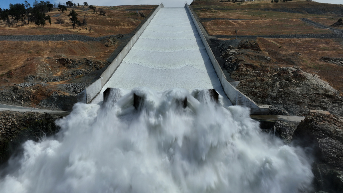 California’s Second Largest Reservoir Hits 100% Capacity After Winter’s Historic Snowfall. OROVILLE, CALIFORNIA - JUNE 15: In an aerial view, water is released on the main spillway at Lake Oroville on June 15, 2023 in Oroville, California. After several winter storms that brought record snowfall to California's Sierra Nevada mountains, Lake Oroville, California's second largest reservoir, is at 100 percent capacity. The lake has only reached full pool twice in the past 15 years with the most recent time in 2019. (Photo by Justin Sullivan/Getty Images)