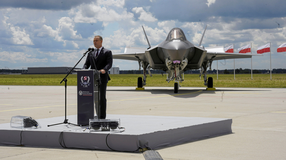 Poland's President Karol Nawrocki speaks in front of a newly acquired Polish F-35 Lightning II stealth strike fighter, named 'Husarz' in reference to the Polish "winged hussar" cavalry units, on the day of a ceremony marking their official induction into the Polish Armed Forces at the 32nd Tactical Air Base in Lask, Poland, June 12, 2026.  Agencja Wyborcza.pl/Marcin Stepien/via REUTERS