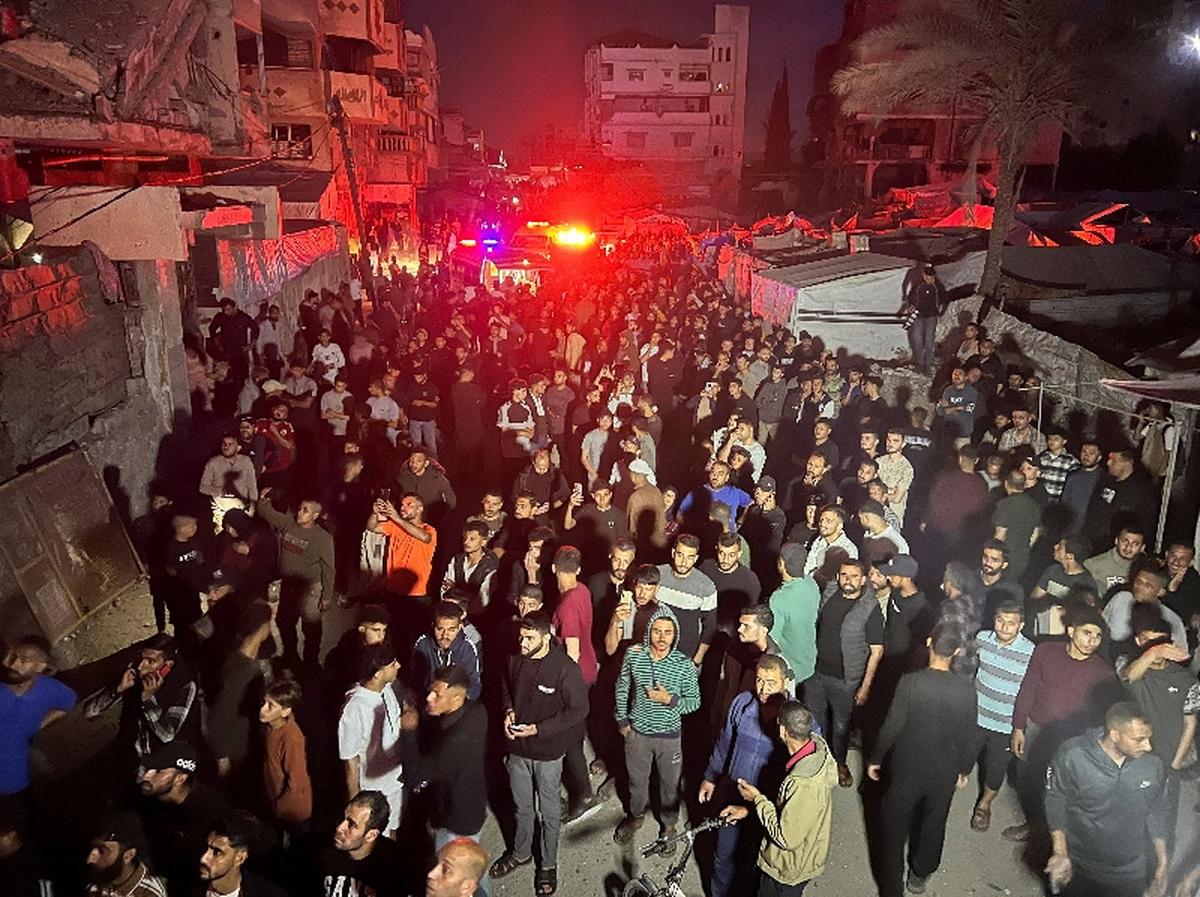 People gather around a residential apartment as a fire burns after Israeli shelling, according to the Ministry of Health, in Gaza City May 15, 2026. REUTERS/Ebrahim Hajjaj