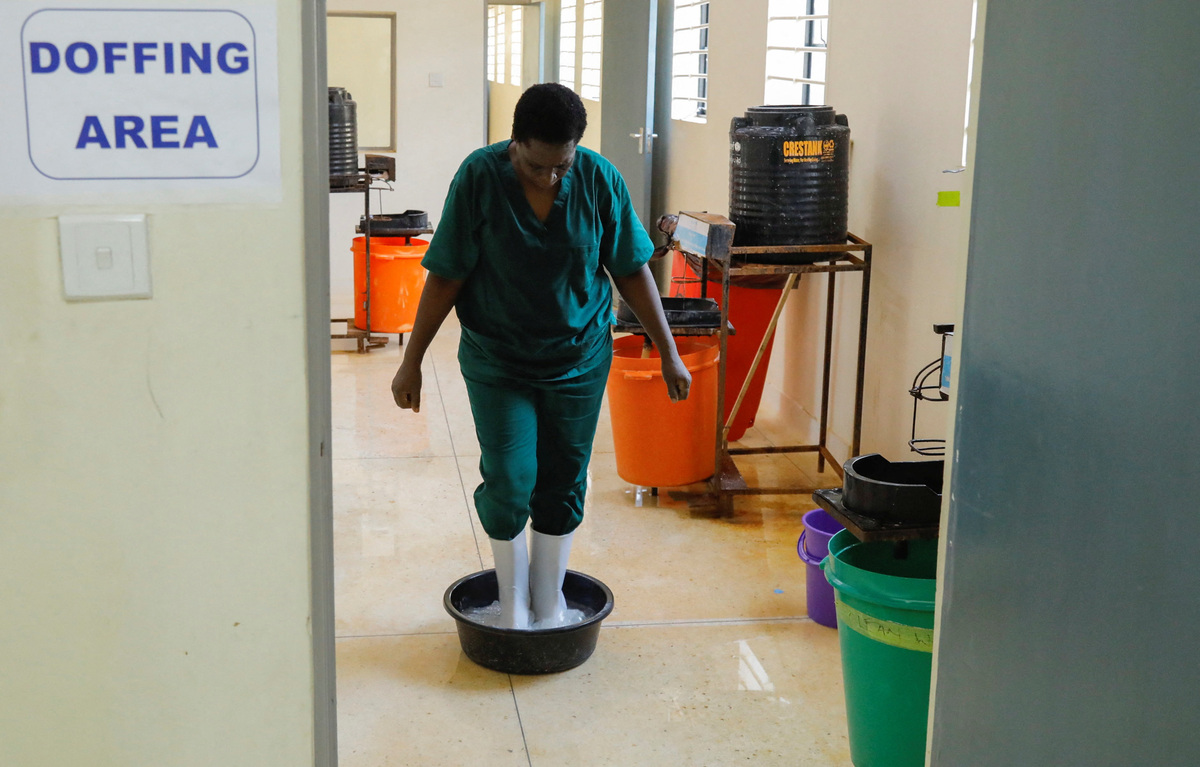 A Ugandan medical worker stands at the doffing area during a visit by the Director-General of the World Health Organisation (WHO) Tedros Adhanom Ghebreyesus at the Mulago National Referral Hospital Isolation Unit, as aid agencies intensify efforts to contain a new Ebola outbreak involving the Bundibugyo Virus, in Mulago suburb, of Kampala, Uganda June 8, 2026. REUTERS/ Abubaker Lubowa