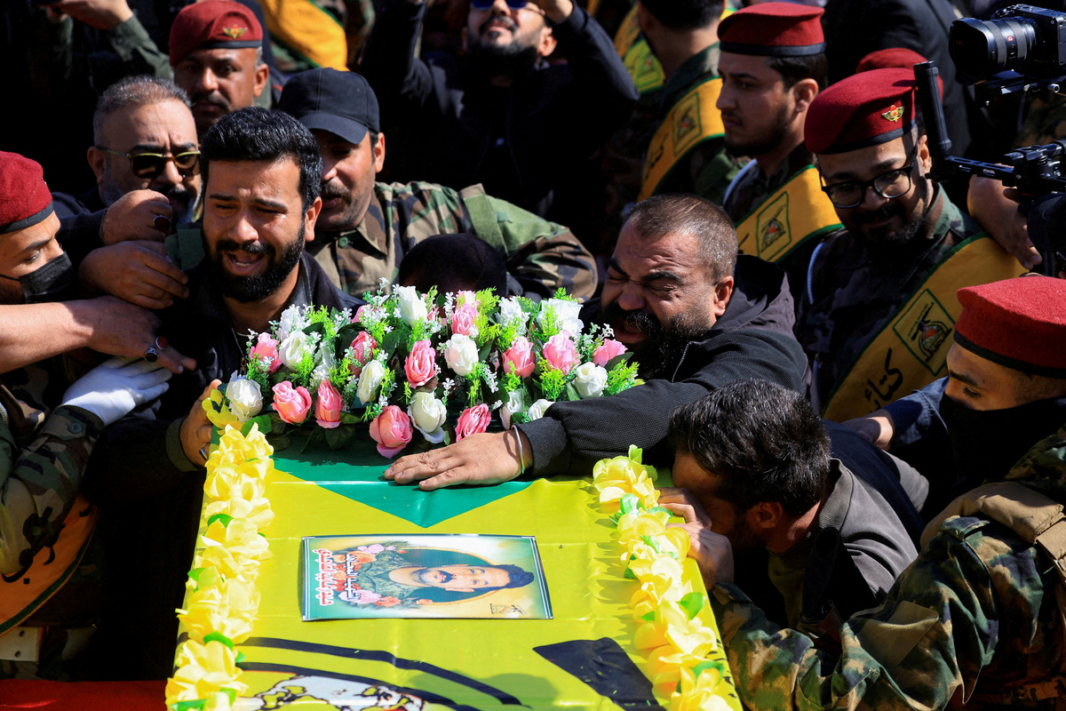 FILE PHOTO: Mourners attend the funeral procession of Ali Hassan Abdullah, a commander from Islamic Resistance in Iraq, and people who were accompanying him and were killed in an airstrike that targeted their vehicle south of Baghdad, according to police sources, in Baghdad, Iraq, March 5, 2026. REUTERS/Thaier Al-Sudani/File Photo