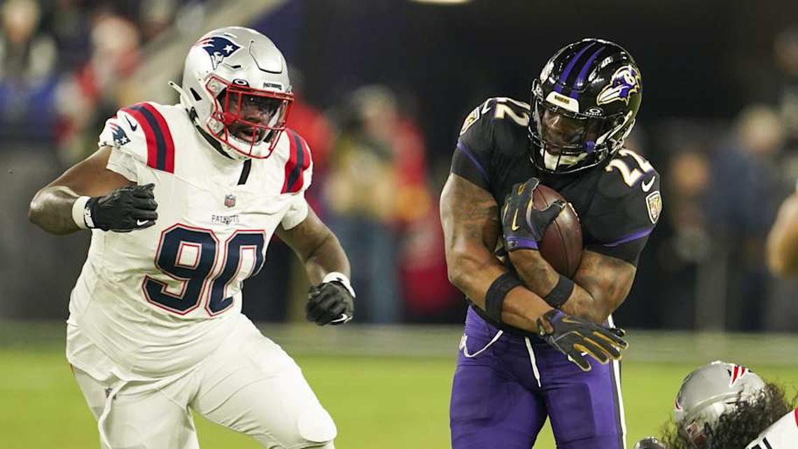  Dec 21, 2025; Baltimore, Maryland, USA; Baltimore Ravens running back Derrick Henry (22) runs the ball against New England Patriots defensive tackle Christian Barmore (90) and linebacker Jahlani Tavai (48) during the first quarter of the game at M&T Bank Stadium. Mandatory Credit: Mitch Stringer-Imagn Images | Mitch Stringer-Imagn Images 