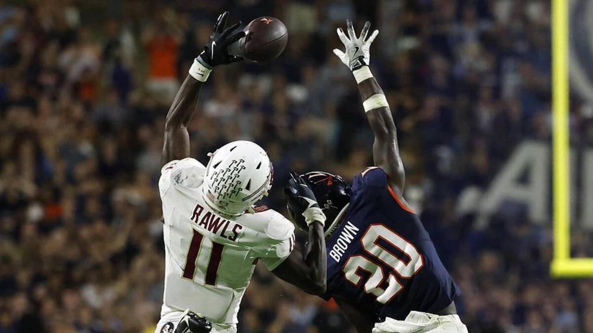  Sep 26, 2025; Charlottesville, Virginia, USA; Florida State Seminoles defensive back Ja'Bril Rawls (11) attempts to catch a pass intended for Virginia Cavaliers running back Xavier Brown (20) at Scott Stadium. Mandatory Credit: Geoff Burke-Imagn Images | Geoff Burke-Imagn Images 