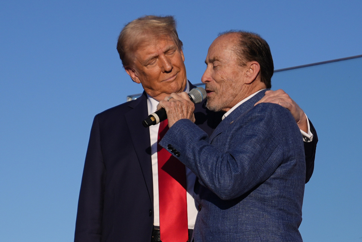  Republican presidential nominee former President Donald Trump greets Lee Greenwood as he arrives at a campaign rally at the Butler Farm Show, Saturday, Oct. 5, 2024, in Butler, Pa. (AP Photo/Evan Vucci) 