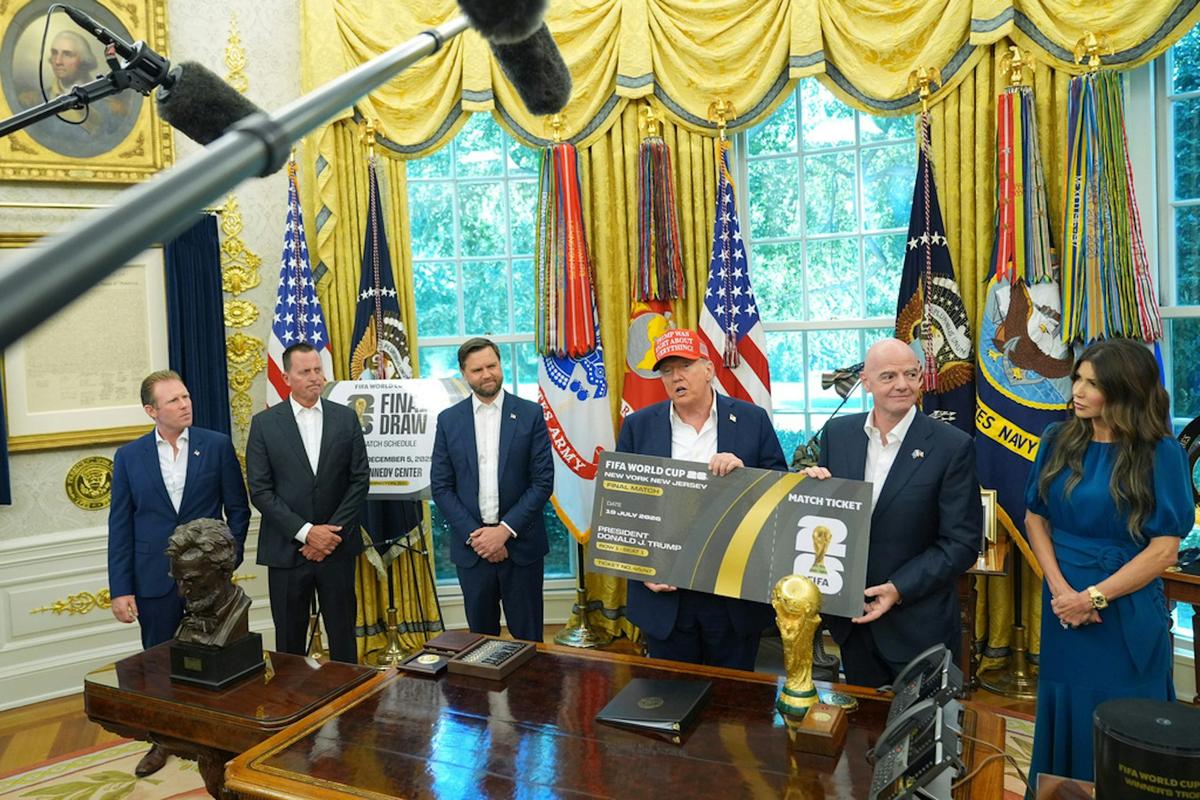  President Donald Trump speaks holding a large ticket representing a ticket for the World Cup final, alongside FIFA President Gianni Infantino on Aug. 22, 2025. AP Photo/Jacquelyn Martin 