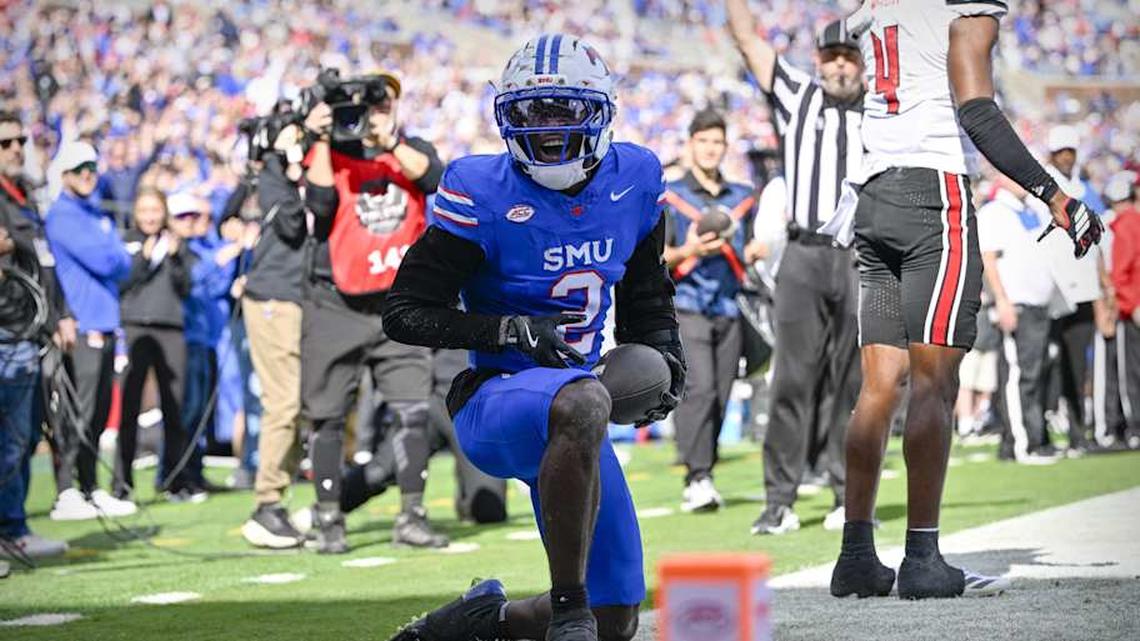  Nov 22, 2025; Dallas, Texas, USA; SMU Mustangs wide receiver Jordan Hudson (2) celebrates after he scores a touchdown against the Louisville Cardinals during the first half at Gerald J. Ford Stadium. Mandatory Credit: Jerome Miron-Imagn Images | Jerome Miron-Imagn Images 