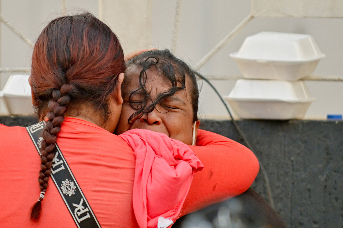 People embrace, as rescue operations continue after earthquakes hit the country in La Guaira, Venezuela, June 27, 2026. REUTERS/Maxwell Briceno