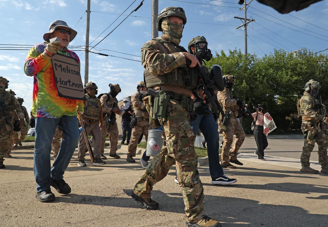 Protesters and activists shout down federal agents while vans enter the Immigration and Customs Enforcement facility in Broadview on Sept. 12, 2025. (Dominic Di Palermo/Chicago Tribune)
