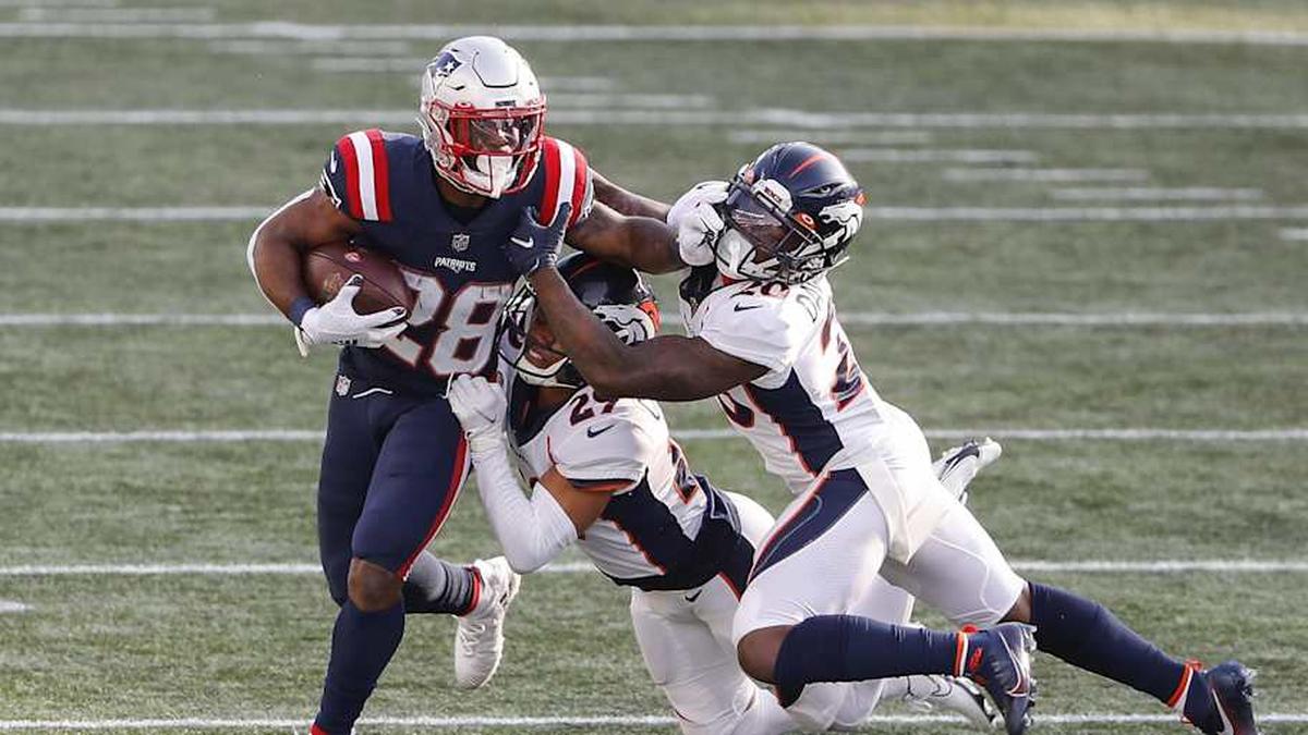 Oct 18, 2020; Foxborough, Massachusetts, USA; Denver Broncos cornerback Duke Dawson Jr. (20) and cornerback Bryce Callahan (29) combine to bring down New England Patriots running back James White (28) during the second half at Gillette Stadium. Mandatory Credit: Winslow Townson-Imagn Images | Winslow Townson-Imagn Images 