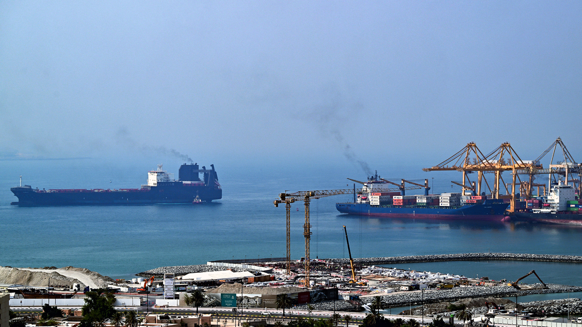 Ships are docked along a pier at the Khor Fakkan Container Terminal, the only natural deep-sea port in the region and one of the major container ports in Sharjah Emirate, along the Gulf of Oman on July 14, 2026. Tehran announced it was closing the Strait of Hormuz on July 12 and launched missiles and drones at its Gulf neighbors, in retaliation for new US strikes following an attack by Iranian forces on a merchant vessel that was abandoned in flames by its crew. (AFP/Getty Images/TNS)