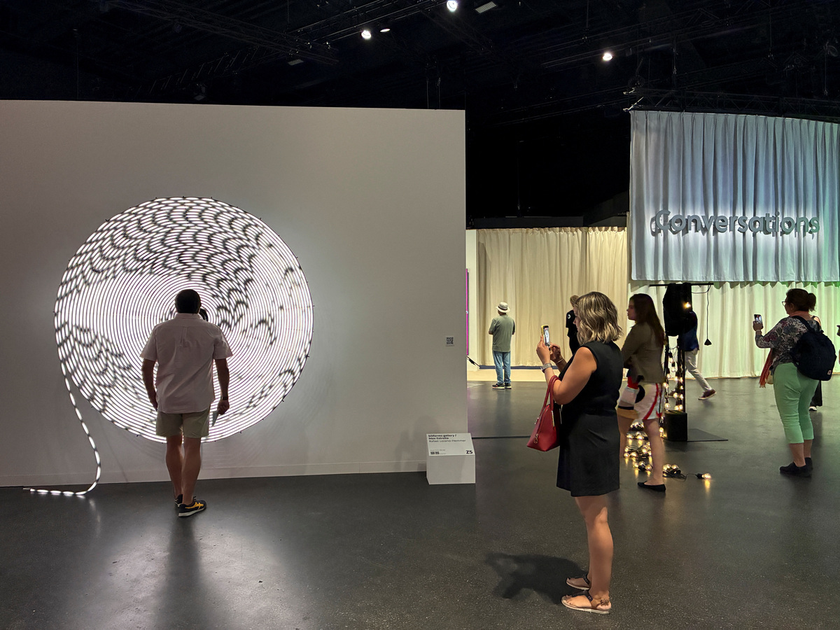 Visitors walk by a sign pointing to the Art Basel Zero 10 exhibition, June 17, 2026. REUTERS/Marleen Kaesebier