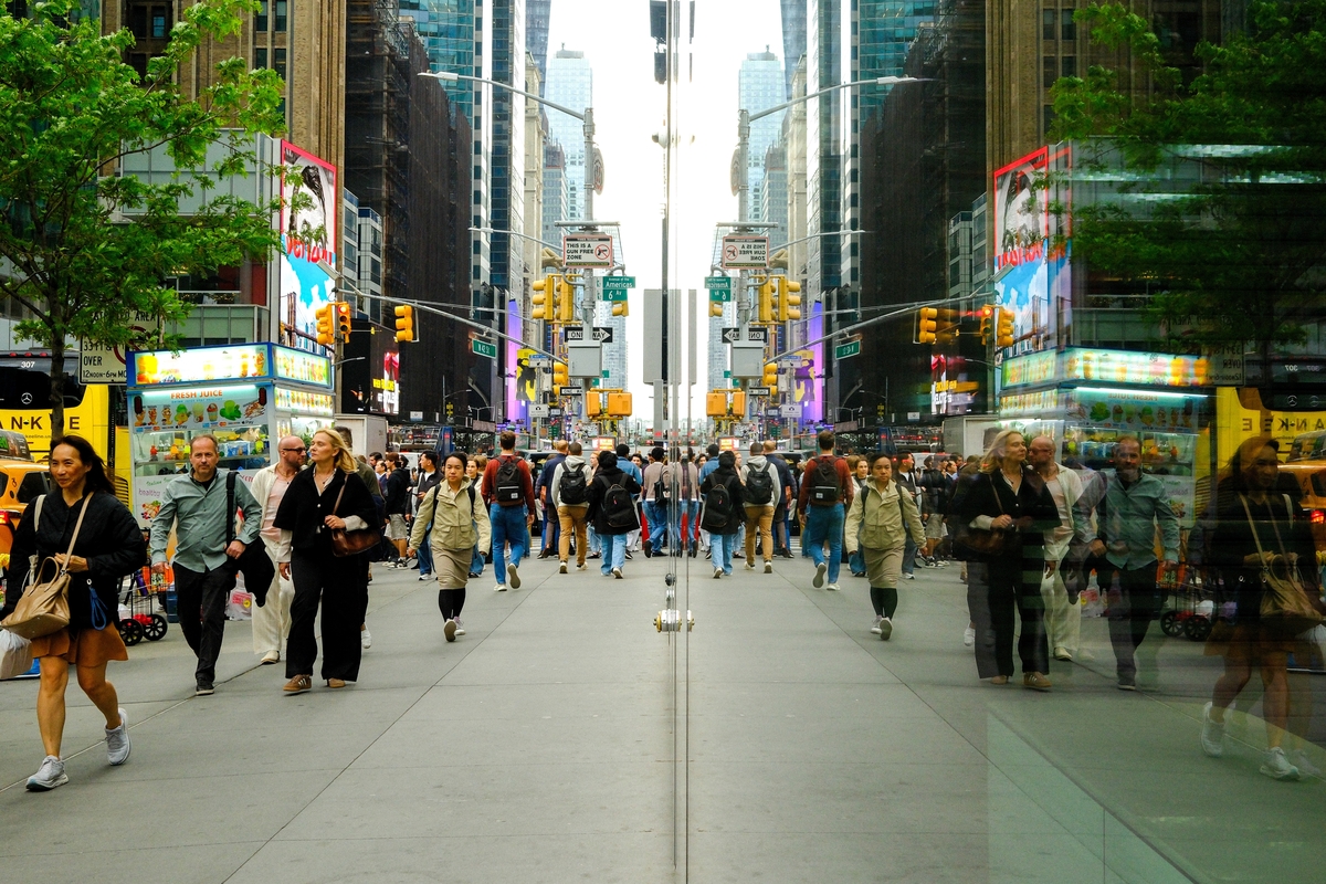  Pedestrians and vehicles are reflected in a window on Sixth Avenue and 42nd Street in Manhattan, New York City, on May 13, 2026. 