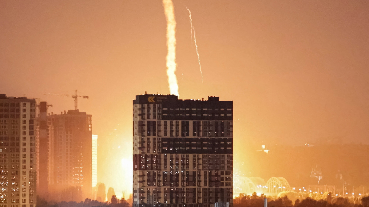 An explosion lights up the sky over the city during a Russian missile and drone strike in Kyiv, Ukraine, on Monday. At least 28 people were killed in the bombardment of the capital city and the surrounding region.