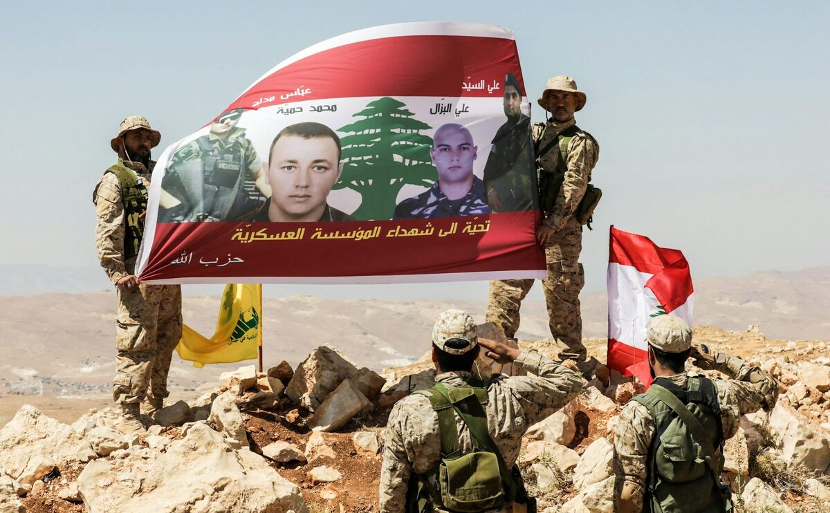  Hezbollah fighters salute a banner in a mountainous area around the Lebanese-Syrian border town of Arsal on July 26, 2017. Anwar Amro/AFP via Getty Images 