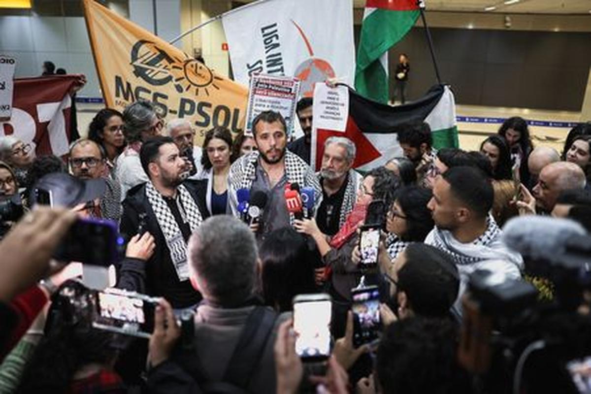 Brazilian activist Thiago Avila, who was detained aboard the Gaza-bound Global Sumud Flotilla, which was intercepted by Israeli forces, speaks to the media upon arrival at Sao Paulo/Guarulhos International Airport after being deported, in Guarulhos, Brazil, May 11, 2026. REUTERS/Amanda Perobelli