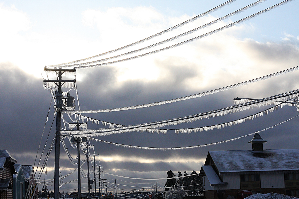  File Photo: A utility pole and power lines heavily encrusted with a thick layer of ice. 