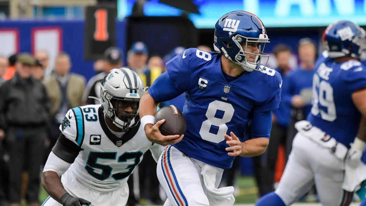New York Giants quarterback Daniel Jones (8) rushes away from Carolina Panthers’ Brian Burns (53) during the first half of an NFL football game, Sunday, Oct. 24, 2021, in East Rutherford, N.J. (AP Photo/Bill Kostroun)