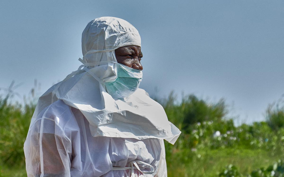 FILE PHOTO: A Red Cross worker wearing personal protective equipment (PPE) attends the burial of Dr Tibenderana Katho Blaise who worked at the Centre Medical Evangelique (CME) in Hoho commune and died of Ebola virus, as aid agencies intensify efforts to contain a new Ebola outbreak caused by the Bundibugyo virus, at the Nyamurongo cemetery in Bunia town, Ituri province, Democratic Republic of Congo, May 26, 2026. REUTERS/Gradel Muyisa Mumbere/File Photo