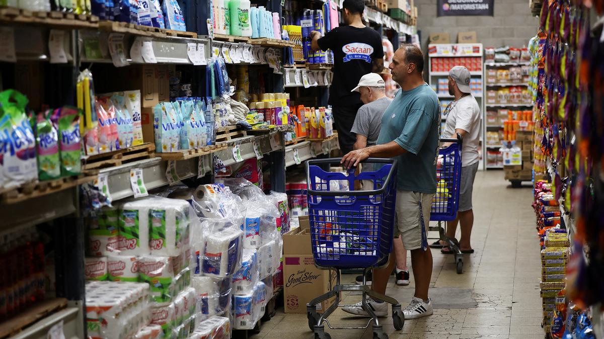 A shopper checks prices at a supermarket, in Villa Martelli on the outskirts of Buenos Aires, Argentina January 13, 2026. REUTERS/Agustin Marcarian